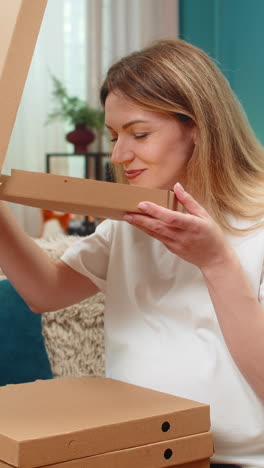 pregnant woman banking app on smartphone holding credit card orders pizza happy dinner anticipation