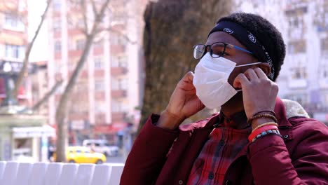 black young man takes off his mask