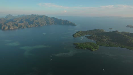 aerial - lush islands surrounded by clear waters in the philippines, showcasing natural beauty