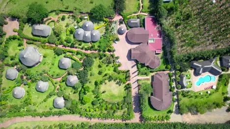 Bird's-Eye-View-Over-Roofs-Of-Emburara-Farm-Lodge-In-Uganda---drone-shot