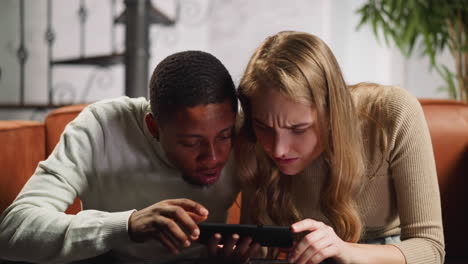 amazed man with pregnant wife watches ultrasound record