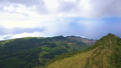 panoramic aerial view of a lush green coastal landscape with a village