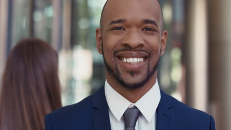 portrait of african american businessman outside corporate office building