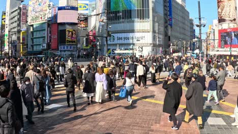 pedestrians crossing a busy city intersection