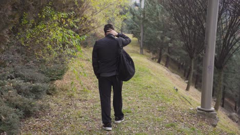 the sad and pensive young man walking outdoors.