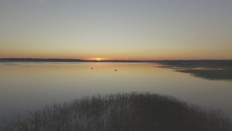 boats on the lake in a calm evening at sunset