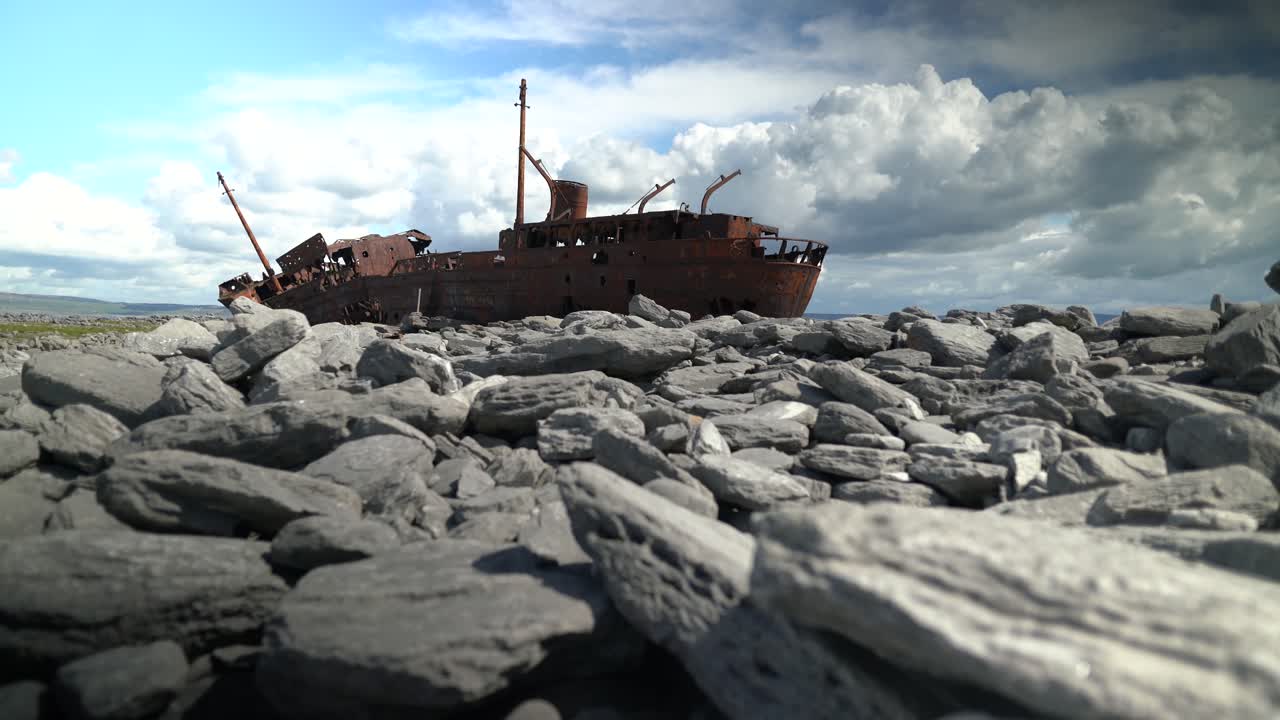 Et dramatisk vidvinkelbillede af det ikoniske MV Plassy-skibsvrag, der hviler på kalkstensklipperne ved Inisheer. Ideel til rejsedokumentarer og historiefortælling.