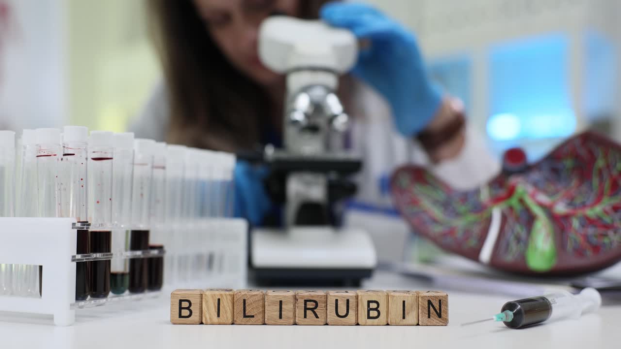 Laboratory worker carefully examines blood sample of patient