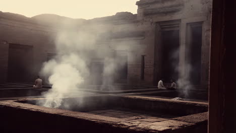 Meditating Figures in a Smoky Ancient Temple Courtyard