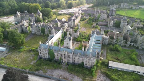 haunted denbigh lunatic asylum, north wales, aerial slow anticlockwise rotate and move in and over, sunny afternoon