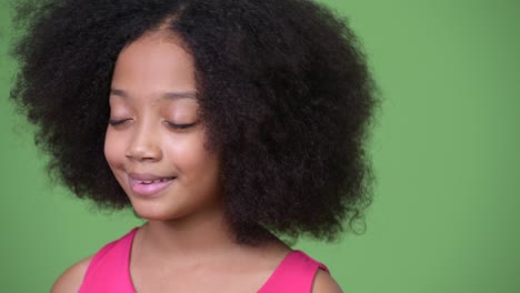 young cute african girl with afro hair relaxing with eyes closed