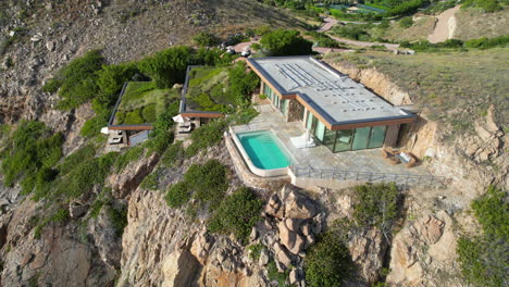 drone shot of villa with swimming pool on hill above caribbean sea, virgin gorda, british virgin islands