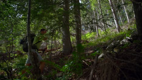 Man-hiking-in-the-forest-to-the-mountain