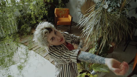 girl dancing in room filled with plants