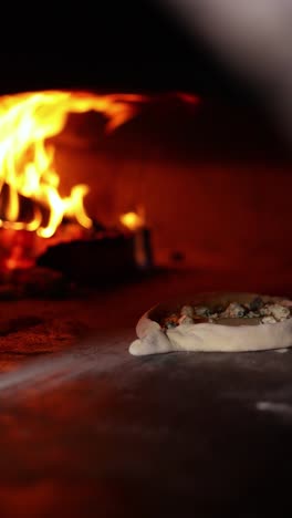 pizza baking in a wood-fired oven