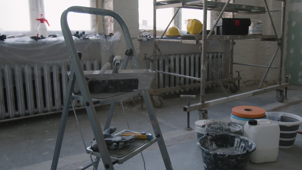 Construction site with ladder, tools, and materials