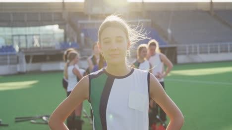 female hockey players smiling and looking at camera