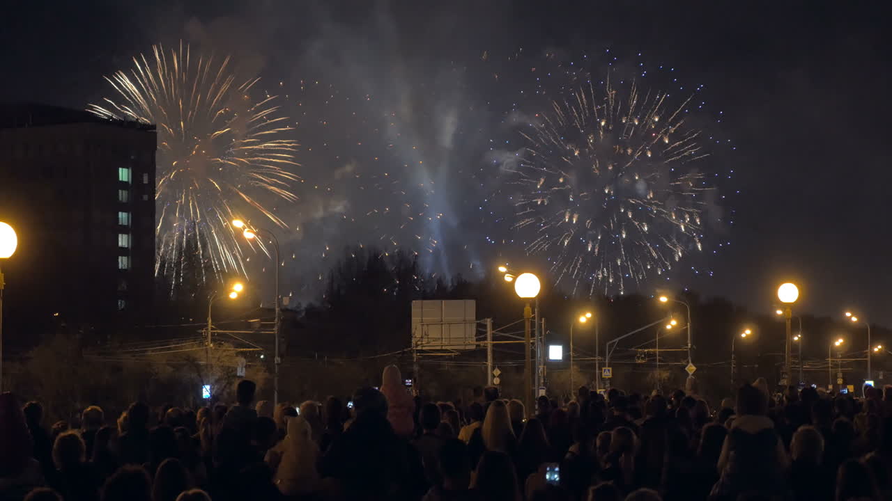personas disfrutando de fuegos artificiales en la ciudad