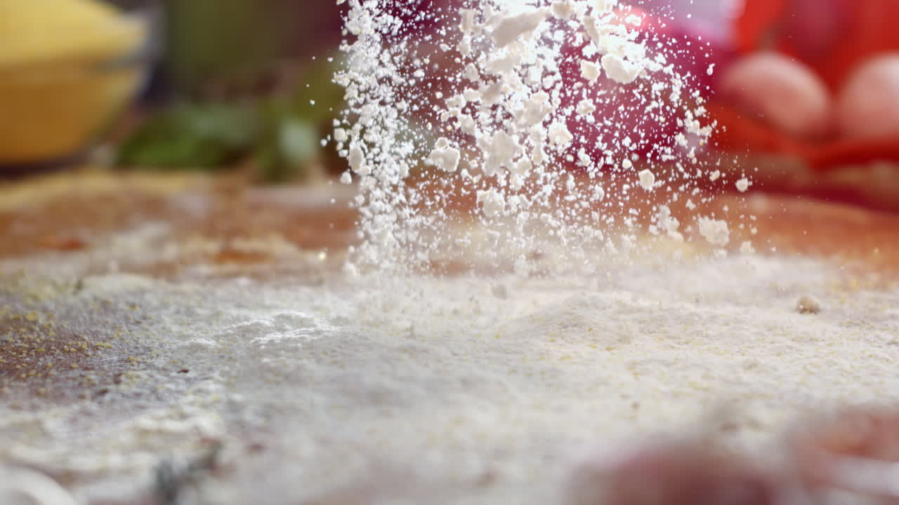 Flour falling onto a table for baking preparation