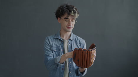 young man holding a baseball glove