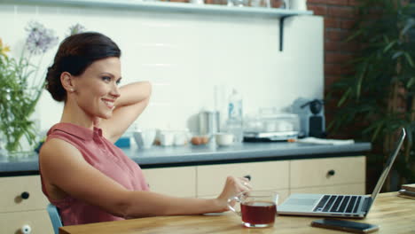 Business-woman-finishing-work-on-laptop.-Young-girl-drinking-tea-at-home.