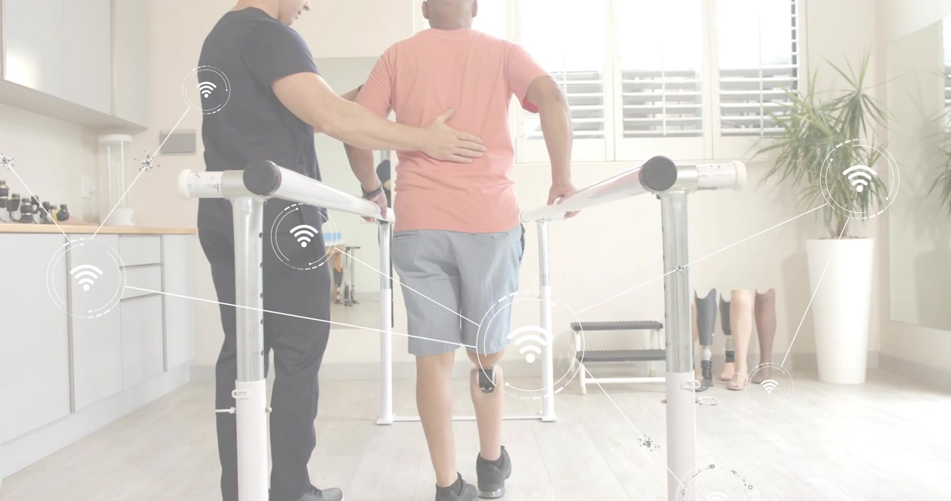 Patient stepping onto bar set activating sensor graphics as therapist steadying posture for rehab
