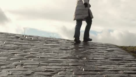 walking up steep cobbled street