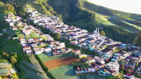 Aerial-epic-4K-shot-of-rural-village-on-the-green-slope-of-a-volcano-in-Indonesia