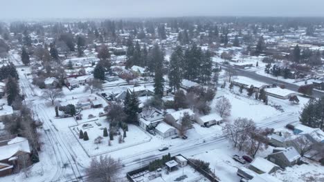 High-up-aerial-view-of-snow-covering-the-land-with-houses-ready-for-winter