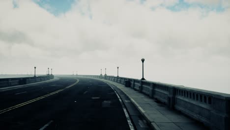 long bridge in misty fog