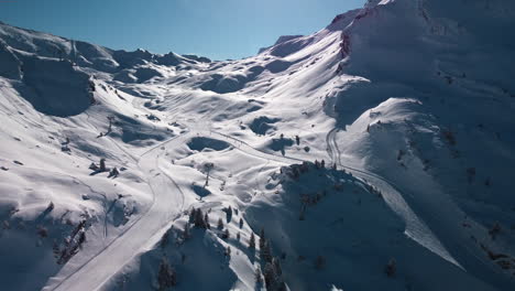 aerial view of groomed ski run, chair lift, people skiing at avoriaz ski resort, french alps