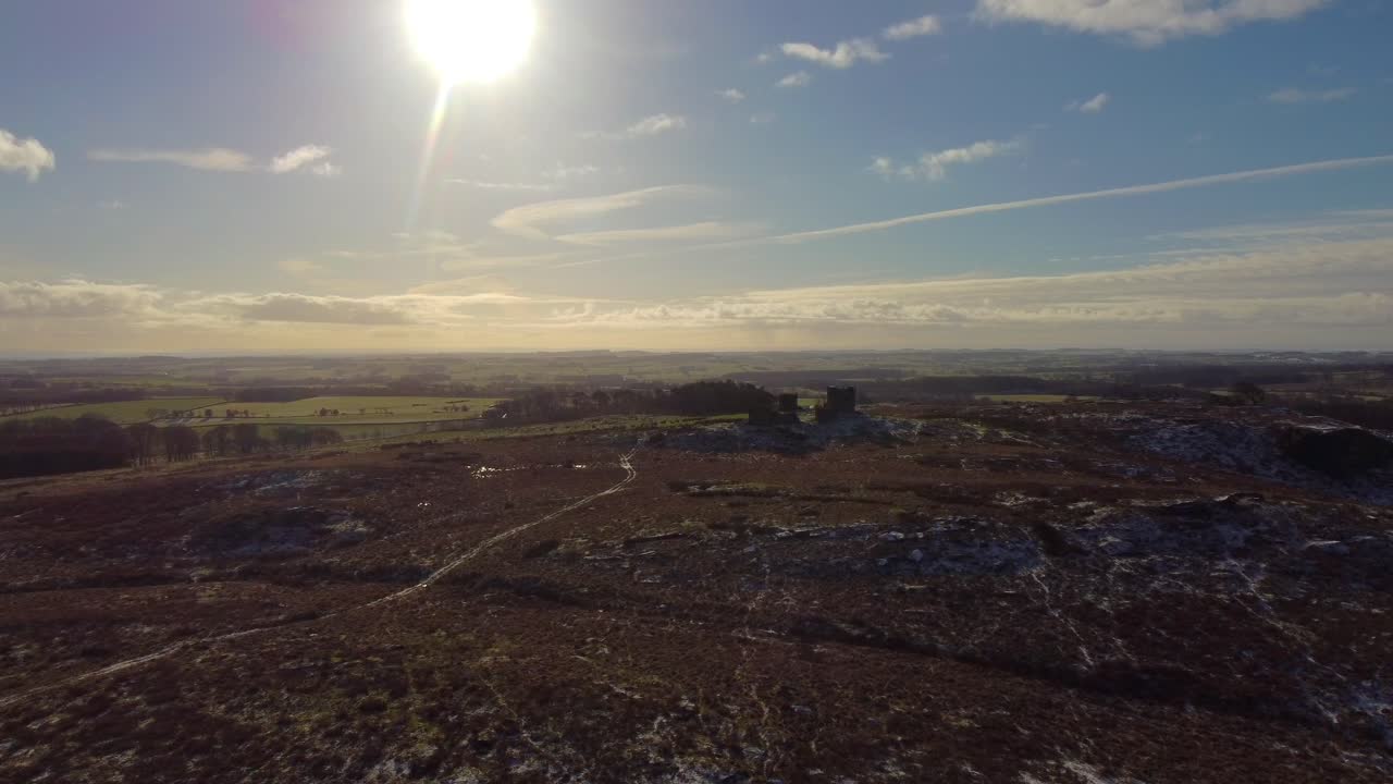Sun-drenched flyover Rothley Castle, Northumberland. Dolly Shot.