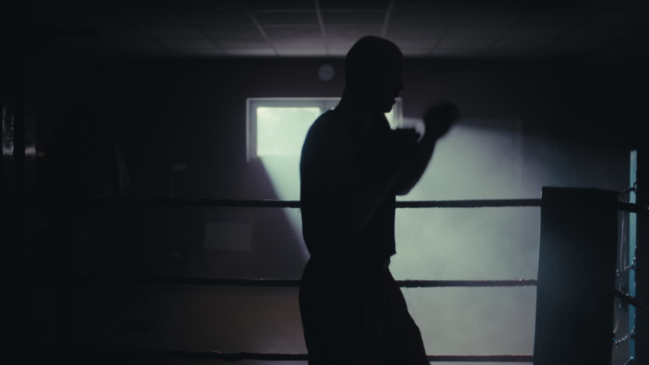 Silhouette of Boxer Training in the Ring