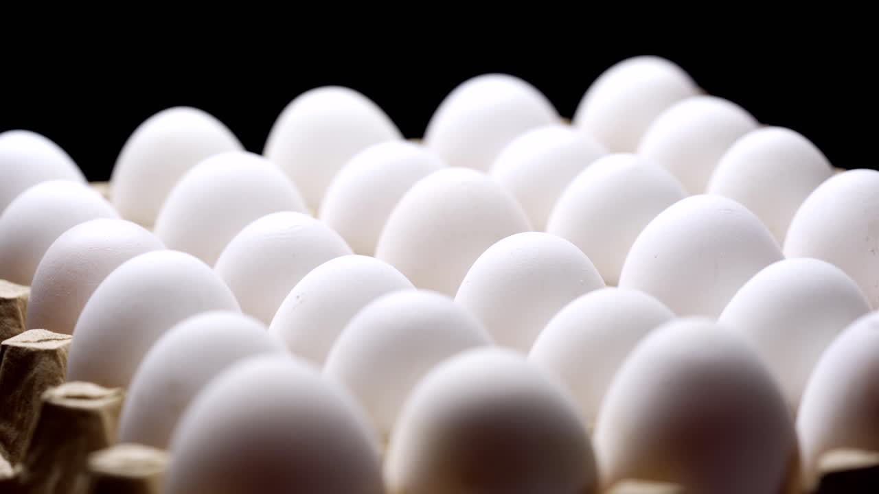White chicken eggs in a cardboard box. Eggs in a paper tray.