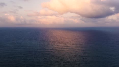 Sunset-over-seascape-reflected-on-water-drone-aerial-view