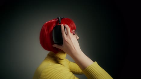 woman with headphones and vibrant yellow sweater