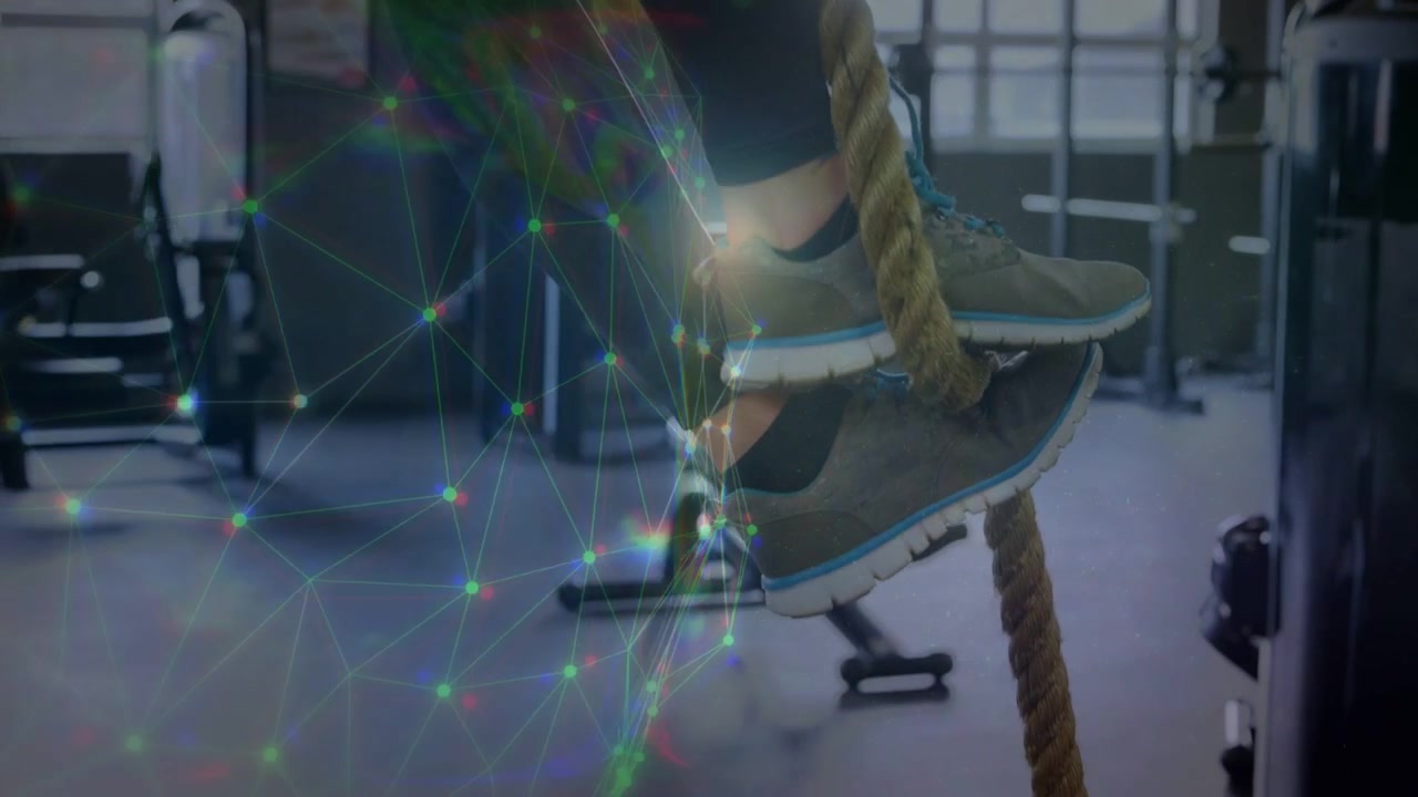 Woman gripping rope and alternating foot hooks, ascending for fitness while network overlay growing