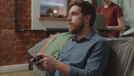 boy playing video games sitting on the floor in bedroom 1