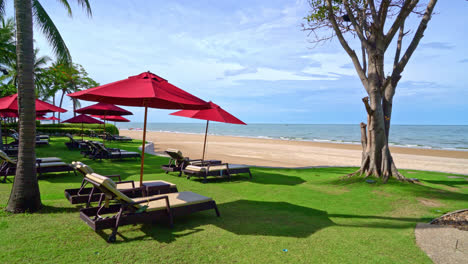 red umbrella and beach chair with sea beach background and blue sky and sunlight