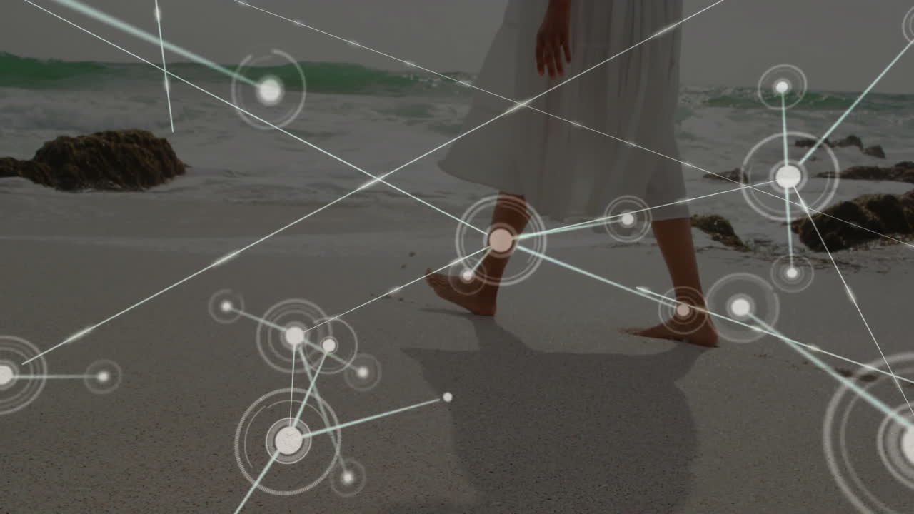 Network of connections and data processing animation over person walking on beach