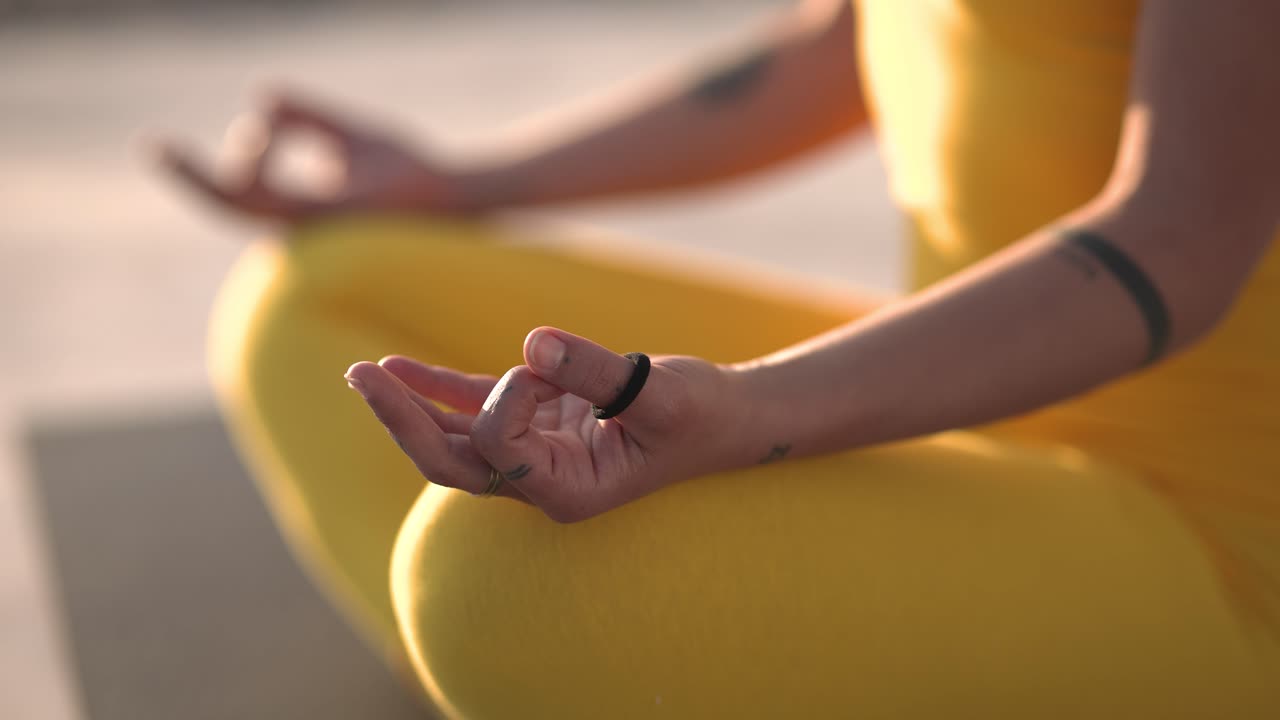 Woman meditating outdoors, holding gyan mudra hand gesture