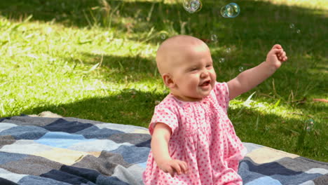 baby girl playing with bubbles