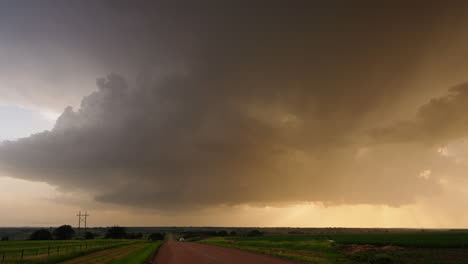 ominous storm clouds over a rural dirt road