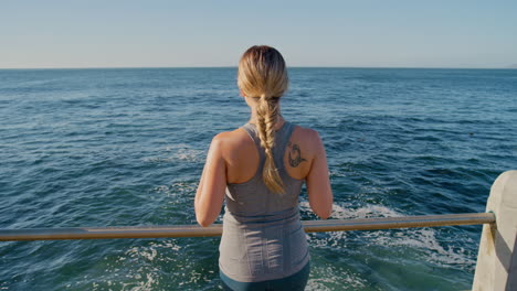 Woman,-fitness-and-relax-by-the-beach-water