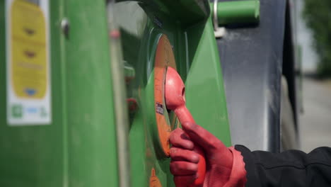 farmer preparing field sprayer with plant protection products