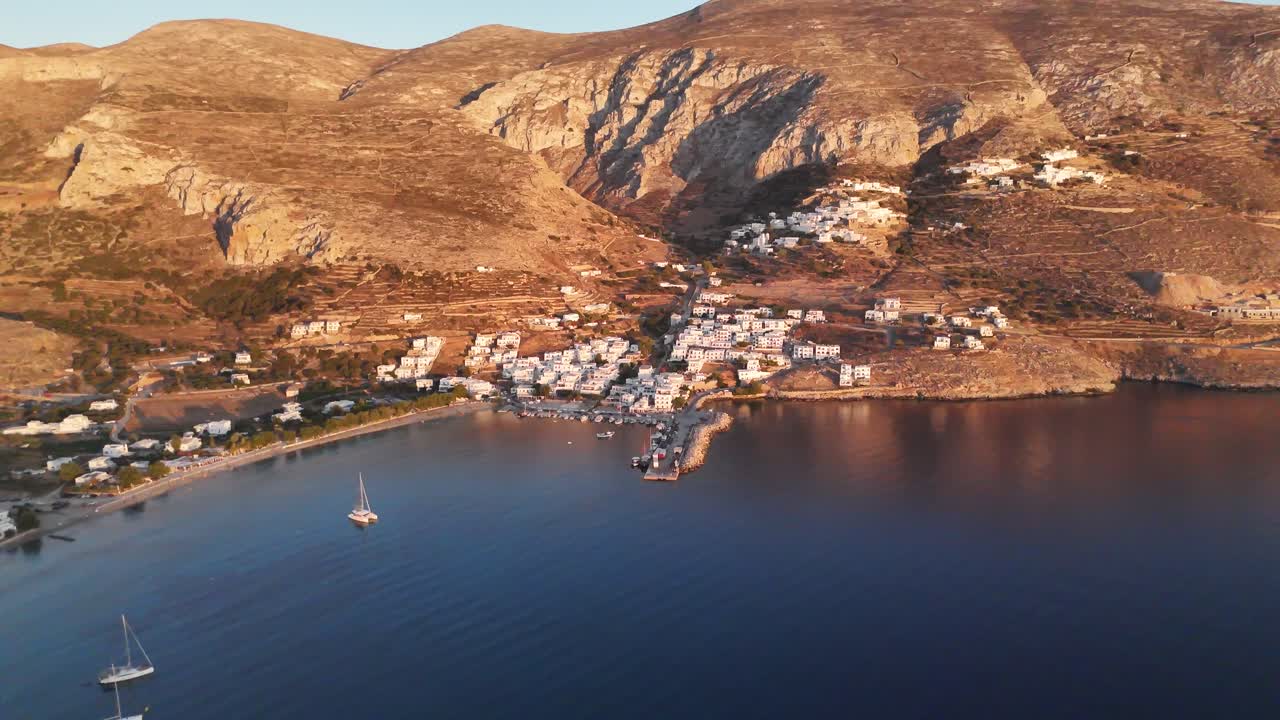 Sunset at port of Aigiali in the beatiful Greek island of Amorgos | 4K drone shot