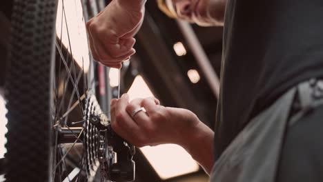 crop mechanic using wrench and adjusting bicycle wheel spokes