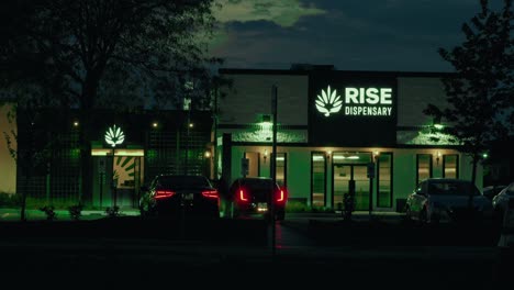 canabis store night timelapse of legal dispensary in mundelein illinois usa. custumers enters the building to buy weed. twilight- nite time. editorial