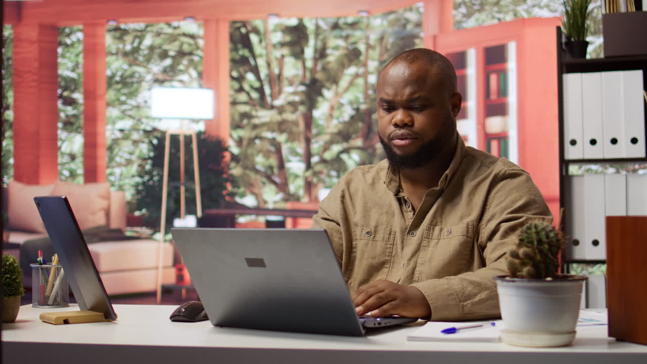 Freelancer writing business reports and managing finance on his laptop