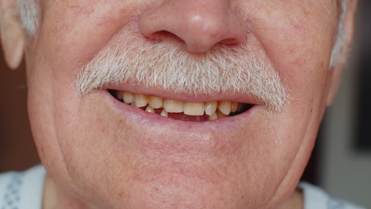 Toothless male smile mouth of senior elderly old man dental problem bad rotten teeth loss caries
